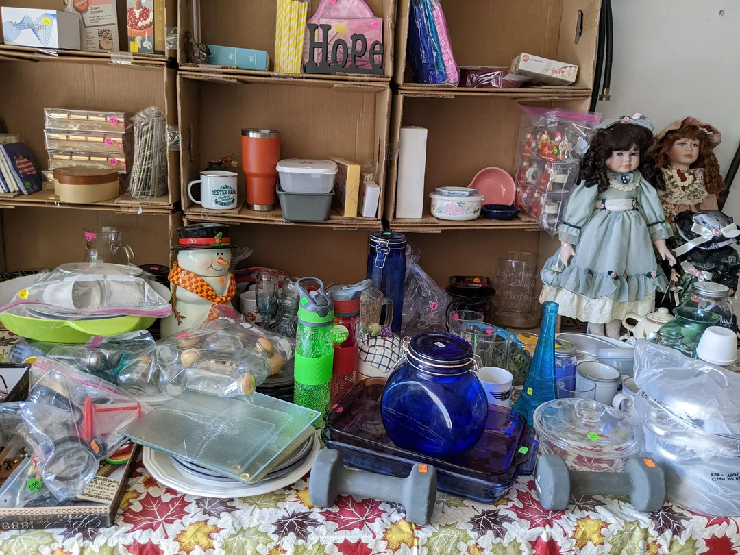An easy way to make shelves for a garage sale by using boxes.